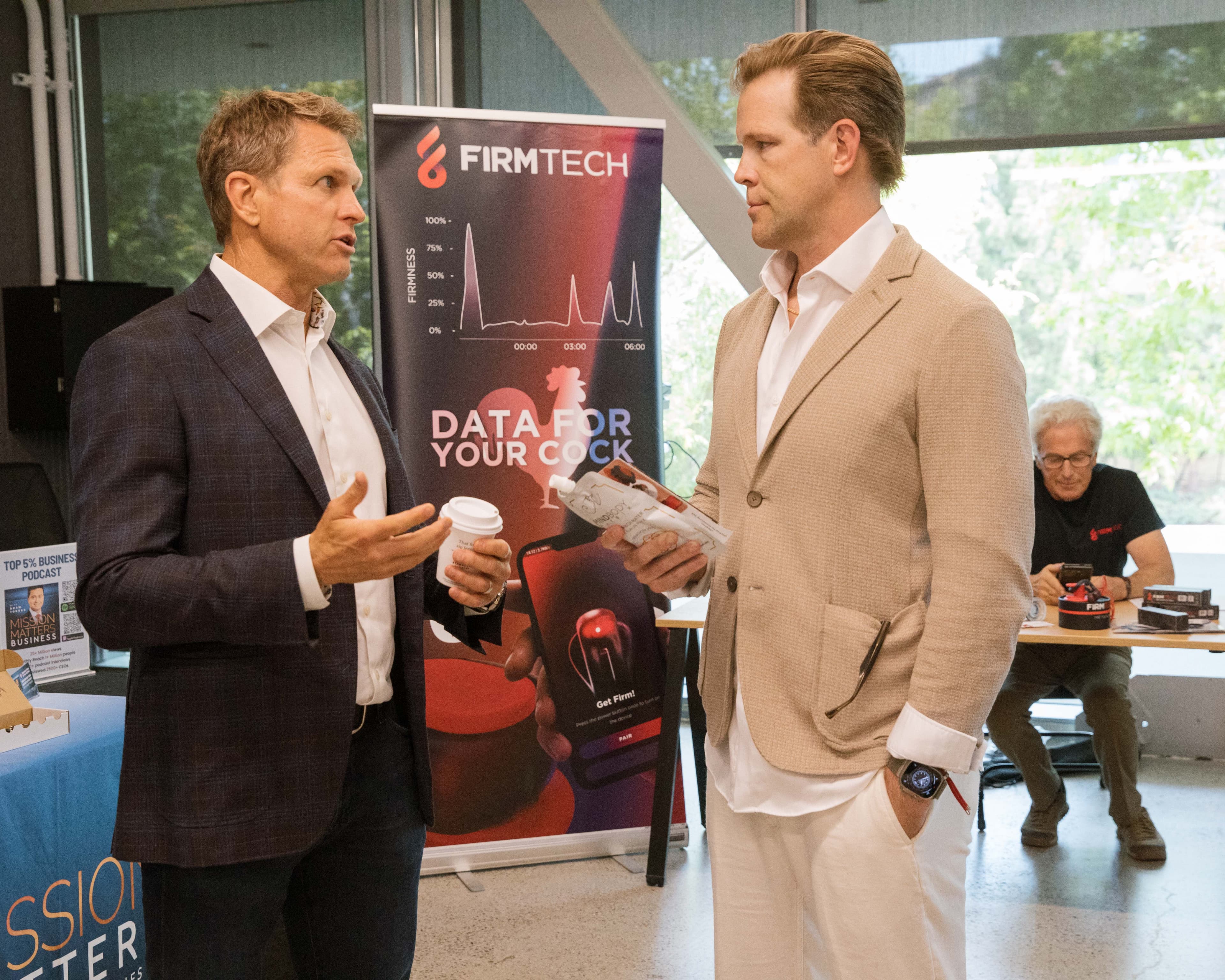 Attendees chatting at vendor booth